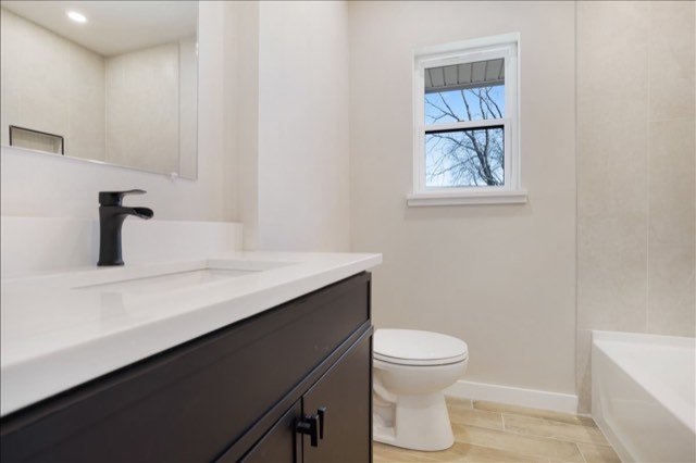 Bathroom with dark vanity and tub