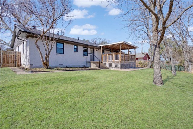 Back of the home with covered deck