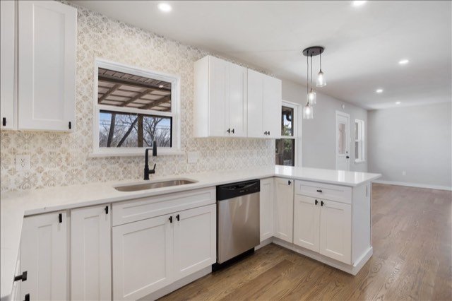 White kitchen with peninsula and pendant lights