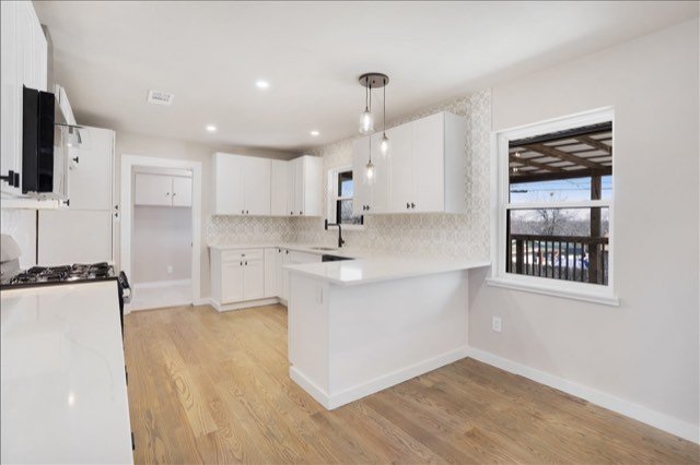 Kitchen peninsula with pendant lights